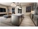 Stylish kitchen island with bar seating complemented by modern lighting and stainless appliances at 1643 Boulder St # 205, Denver, CO 80211