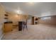 Basement with a fireplace, TV, wet bar, carpet, and a window for natural light at 11972 W Dakota Dr, Lakewood, CO 80228