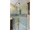 Bathroom highlighting a glass-enclosed tiled shower with a built-in shelf and modern fixtures at 11972 W Dakota Dr, Lakewood, CO 80228