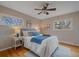 Cozy bedroom with hardwood floors, ceiling fan, and natural light from two windows at 11972 W Dakota Dr, Lakewood, CO 80228