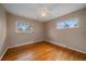 Bright bedroom with hardwood floors, two windows, neutral walls, and a ceiling fan at 11972 W Dakota Dr, Lakewood, CO 80228