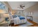 Bedroom featuring hardwood floors, two windows, a ceiling fan, and stylish decor at 11972 W Dakota Dr, Lakewood, CO 80228