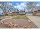 Inviting home with a beautiful yard, large driveway, and lush landscaping at 11972 W Dakota Dr, Lakewood, CO 80228