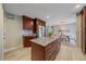 Well-lit kitchen featuring wood cabinets, granite counters, and an island with ample storage at 11972 W Dakota Dr, Lakewood, CO 80228