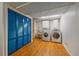 Basement laundry room with blue closet, washer, dryer and utility sink at 11972 W Dakota Dr, Lakewood, CO 80228