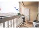 View from balcony with a grill, seating, and a serene winter backdrop at 10487 W Hampden Ave # 101, Lakewood, CO 80227