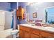 Well-lit bathroom featuring a bathtub with shower and a double sink vanity at 10487 W Hampden Ave # 101, Lakewood, CO 80227