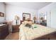 Bright bedroom with light walls and dresser, lamps on each side at 10487 W Hampden Ave # 101, Lakewood, CO 80227