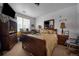 Comfortable bedroom featuring a large window, television, and wooden dresser at 10487 W Hampden Ave # 101, Lakewood, CO 80227