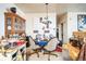 Functional dining area with four chairs, hutch, overhead lighting and clutter at 10487 W Hampden Ave # 101, Lakewood, CO 80227