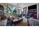 Cozy living room with a fireplace, indoor plants and TV at 10487 W Hampden Ave # 101, Lakewood, CO 80227