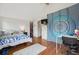 Cozy bedroom features hardwood floors, vaulted ceiling, and closet access at 190 W Archer Pl, Denver, CO 80223