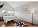 Comfortable bedroom with hardwood flooring, bright windows, and modern decor at 190 W Archer Pl, Denver, CO 80223