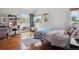 Bright bedroom with a balcony, natural light, wood floors, and a view of the outdoors at 190 W Archer Pl, Denver, CO 80223