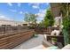 Back deck features outdoor seating, lush plants, and a wood privacy fence at 190 W Archer Pl, Denver, CO 80223