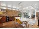 Bright dining area with modern lighting, sleek table, hardwood floors and an accent brick wall at 190 W Archer Pl, Denver, CO 80223