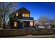 Charming home at twilight, with warm interior lights creating a cozy ambiance and inviting feel at 190 W Archer Pl, Denver, CO 80223