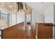 Upstairs hallway with wood railing, modern light fixture and views into the rooms at 190 W Archer Pl, Denver, CO 80223