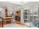 Open kitchen and dining area with stone backsplash, modern cabinets, and an adjacent outdoor patio at 190 W Archer Pl, Denver, CO 80223