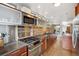 Modern kitchen boasts stone backsplash, stainless steel appliances, wood floors and custom cabinets at 190 W Archer Pl, Denver, CO 80223