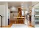 Modern kitchen with wood cabinets, stainless steel appliances, and an adjacent dining area with unique seating at 190 W Archer Pl, Denver, CO 80223
