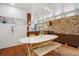 Bright kitchen featuring modern cabinetry, stone backsplash, and a dining area with bench seating at 190 W Archer Pl, Denver, CO 80223
