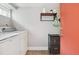 Well-lit laundry room with stacked washer and dryer, providing efficiency at 190 W Archer Pl, Denver, CO 80223