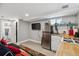 Compact living room with a kitchenette, stainless steel refrigerator, and modern design at 190 W Archer Pl, Denver, CO 80223