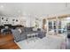 Open living room with hardwood floors, a comfortable gray sofa, and plenty of natural light at 190 W Archer Pl, Denver, CO 80223