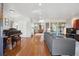 Spacious open-concept living room with hardwood floors, a comfortable gray sofa, and a dining area at 190 W Archer Pl, Denver, CO 80223