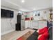 Apartment living room with kitchenette, tv, and neutral decor at 190 W Archer Pl, Denver, CO 80223