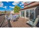 Back deck features a table with seating for six and sliding glass doors to the house at 11321 N Brownstone Dr, Parker, CO 80138