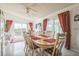 Bright dining room with table set for six and sliding glass doors to the outside at 11321 N Brownstone Dr, Parker, CO 80138