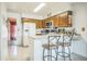Bright kitchen with wood cabinetry, a peninsula counter, and white appliances at 11321 N Brownstone Dr, Parker, CO 80138