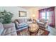 Inviting living room showcasing ample seating, a large window, and neutral decor at 11321 N Brownstone Dr, Parker, CO 80138