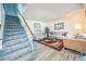 Cozy living room featuring stairs, light wood floors, and comfortable seating at 11321 N Brownstone Dr, Parker, CO 80138