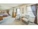 Comfortable main bedroom boasts two chairs, windows for natural lighting, and a dresser at 11321 N Brownstone Dr, Parker, CO 80138