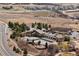 Aerial view of a community pool with clubhouse, parking, and surrounding trees in a neighborhood at 4475 Hidden Gulch Rd, Castle Rock, CO 80104