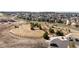 Aerial view of a park with trees, open space, and a paved parking lot within a neighborhood at 4475 Hidden Gulch Rd, Castle Rock, CO 80104