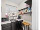 Basement bar with sleek countertop, mini fridge, and convenient shelving at 4475 Hidden Gulch Rd, Castle Rock, CO 80104