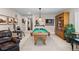 Finished basement with billiards table, bar area, and comfortable seating at 4475 Hidden Gulch Rd, Castle Rock, CO 80104