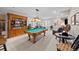 Finished basement featuring a billiards table, cozy sitting area, and custom wood bookcase at 4475 Hidden Gulch Rd, Castle Rock, CO 80104