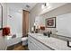 Well-lit bathroom features white cabinetry, granite countertop, framed mirror, and tiled shower/tub at 4475 Hidden Gulch Rd, Castle Rock, CO 80104