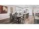 Elegant dining area with stylish table, open to a kitchen with white cabinets and stainless appliances at 4475 Hidden Gulch Rd, Castle Rock, CO 80104