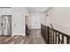 Hallway with hardwood floors, coatrack, and access to different rooms at 4475 Hidden Gulch Rd, Castle Rock, CO 80104