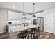 Kitchen island with pendant lights, stainless steel appliances, and granite countertops at 4475 Hidden Gulch Rd, Castle Rock, CO 80104