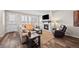 Bright living room featuring hard wood floors, fireplace, and large window with plantation shutters at 4475 Hidden Gulch Rd, Castle Rock, CO 80104