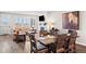 Open-concept living area with a fireplace, tan sofa, and rustic dining table at 4475 Hidden Gulch Rd, Castle Rock, CO 80104