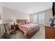 Main bedroom with a floral bedspread, two windows, and wooden furniture at 4475 Hidden Gulch Rd, Castle Rock, CO 80104