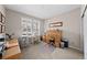 Neutral office with a large window, an oak roll top desk and furnishings at 4475 Hidden Gulch Rd, Castle Rock, CO 80104